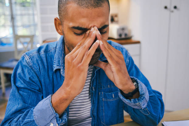 istock Shot of a young man looking stressed while working at home 1347681216