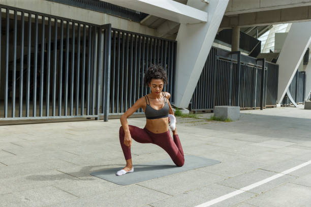 istock Graceful woman does dynamic lunges at yoga training outdoors 1347682304