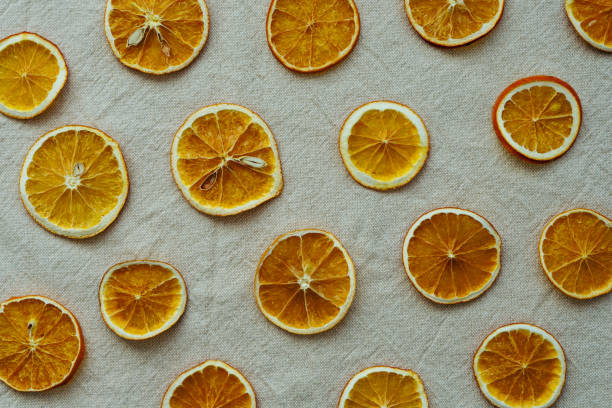 istock Flat lay of dried orange slices on a linen tablecloth 1347682380