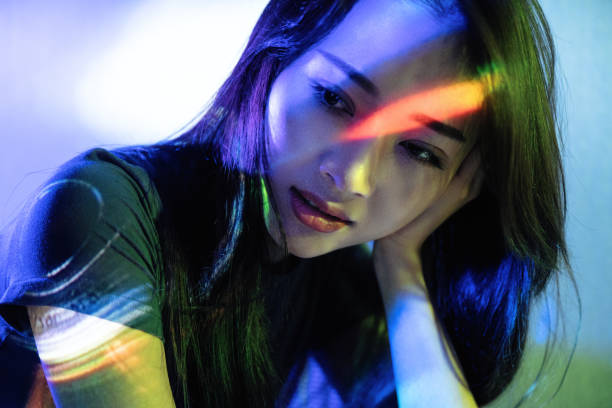 istock Beautiful woman in grey dress under neon light 1347682385