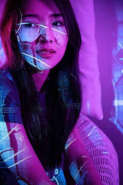 istock Beautiful woman in grey dress under neon light 1347682876