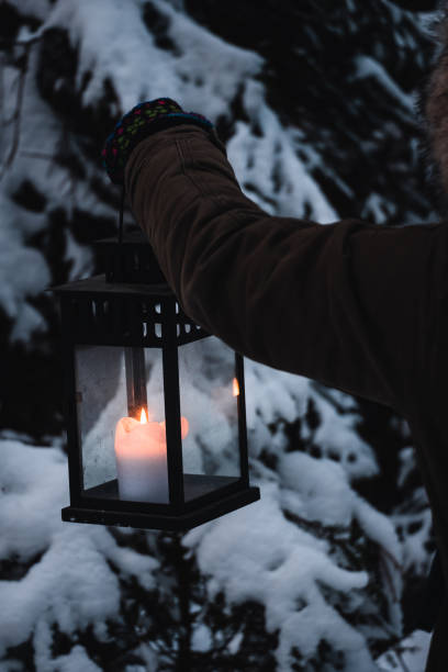 istock Person with lantern in winterly forest 1347683207