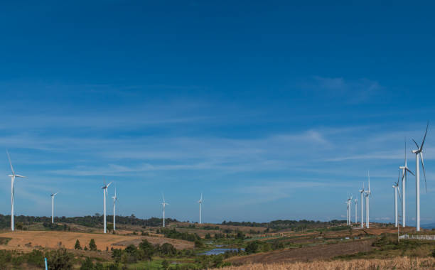 istock Wind turbines generating electricity over blue sky background. 1347683753