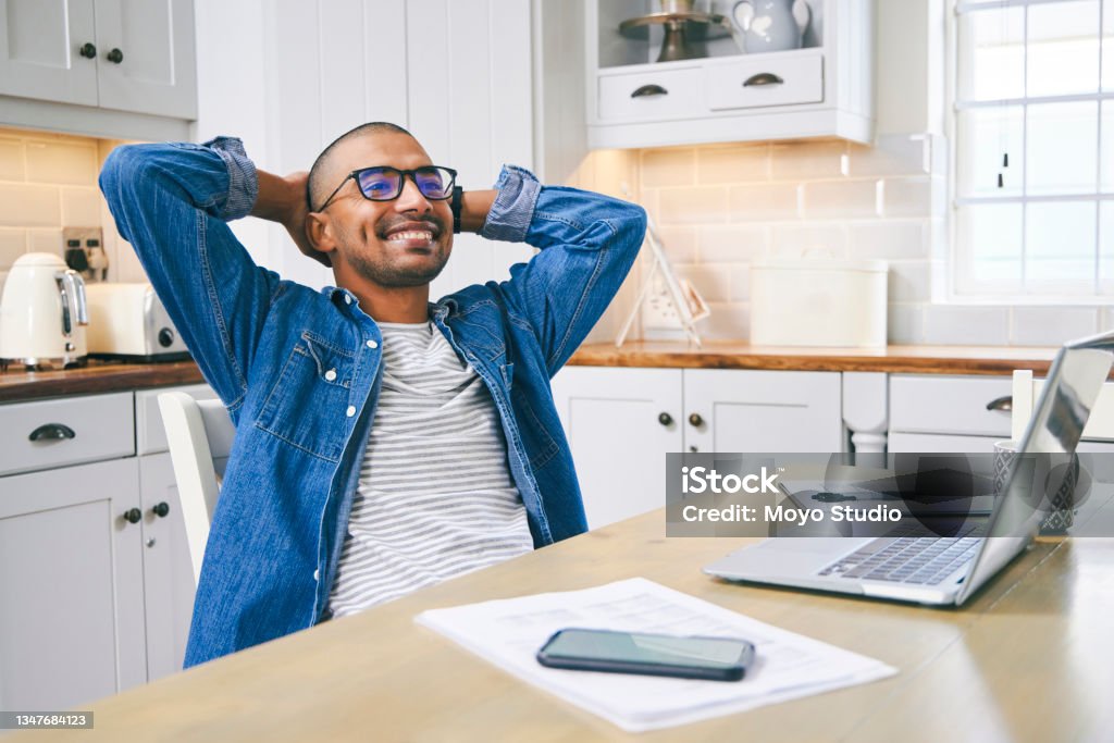 Shot of a young man taking a break while working at home And they said working from home wouldn't work out Debt Stock Photo