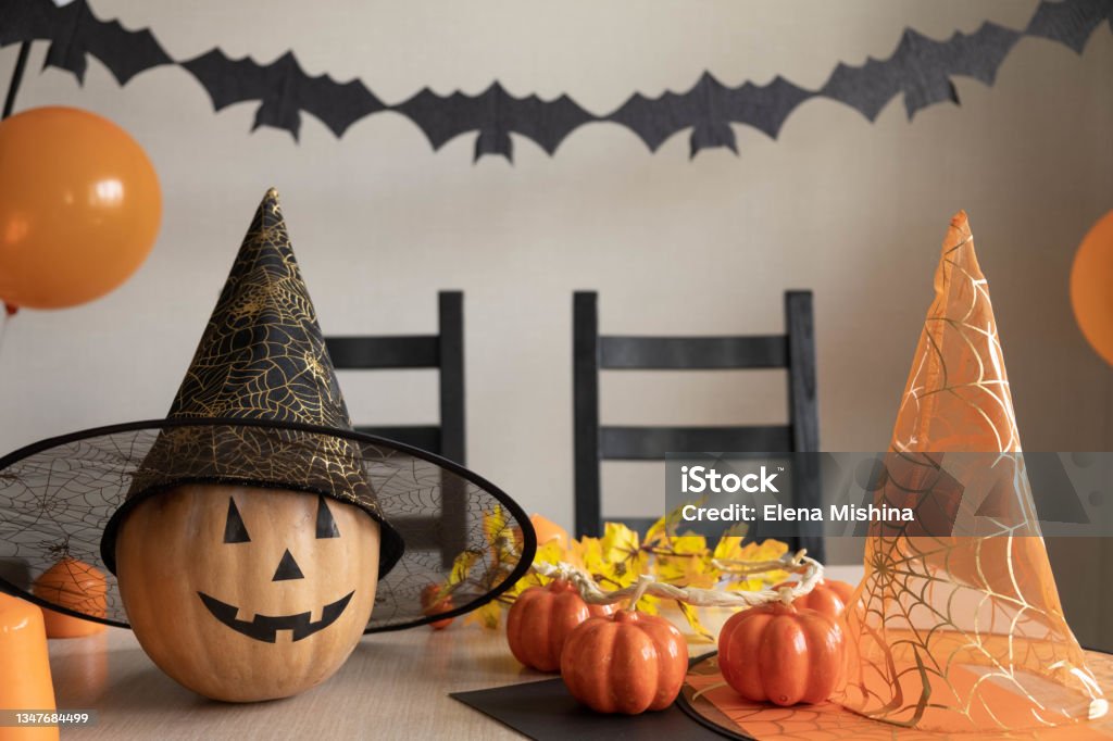 Preparation for Halloween party at home. Room is decorated with pumpkin, balloons, bats and candles. Holiday decoration concept. Selective focus Preparation for Halloween party at home. Room is decorated with pumpkin, balloons, bats and candles. Holiday decoration concept. Selective focus. Backgrounds Stock Photo