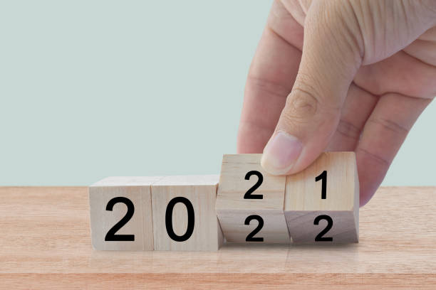 istock New year 2020 change to 2021. Hand flip over wooden cube block. 1347684530