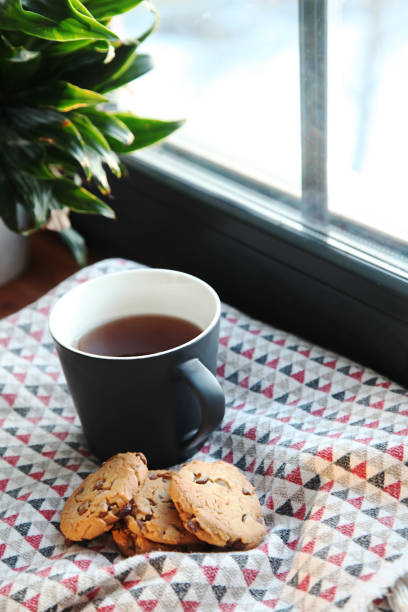 Black cup of drink on the winter window