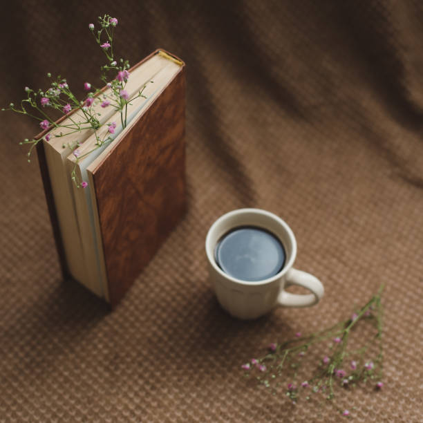 istock A book and cup of coffee on dark background 1347688085