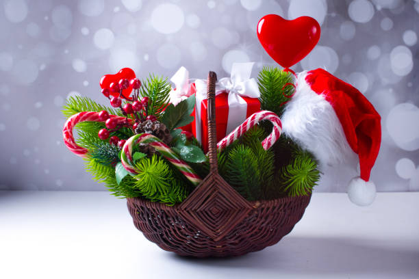 New Year gift basket. Green Christmas tree candy and gift boxes