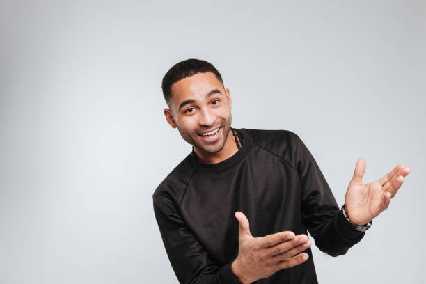 istock Cheerful african american young man showing to the side 1347689617