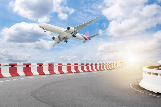 istock white plane flying over low airport road 1347690325