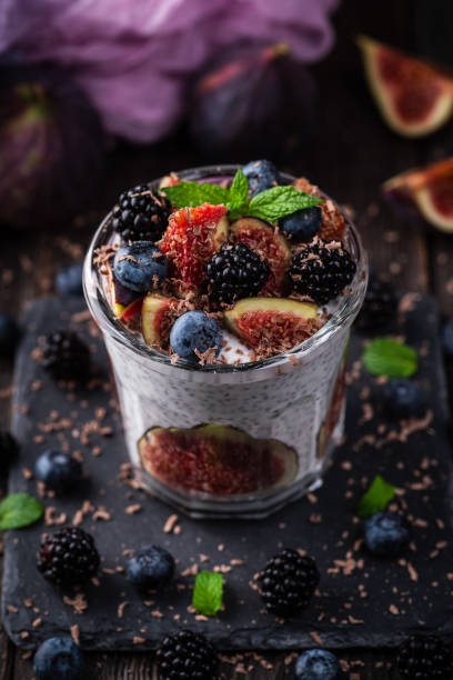istock Healthy chia pudding with figs and dark berries in glass on the rustic background. Selective focus. Shallow depth of field. 1347690363