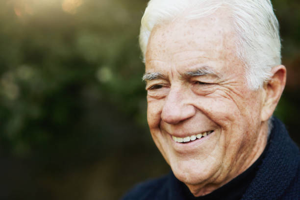 istock White-haired old man smiles happily outdoors in a garden 1347691368
