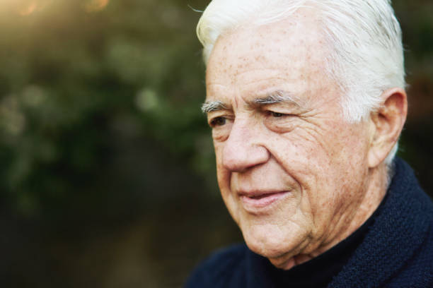 istock White-haired old man looks a little downcast as he thinks about something 1347691400