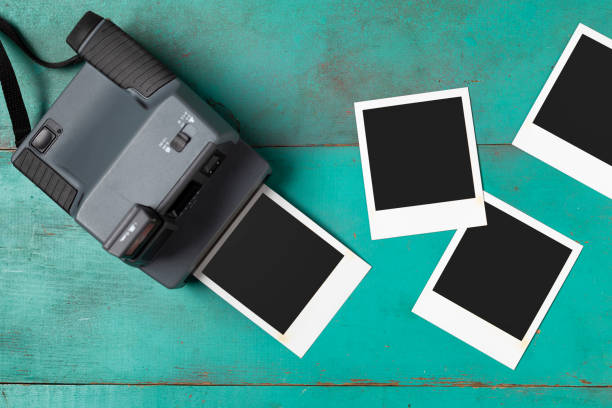 Vintage Instant Camera with Blank Photos - Copy Space stock photo