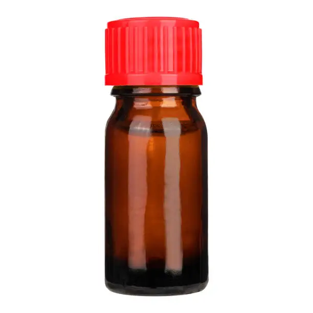 Photo of Amber bottle with orange cap on a white background, isolated.