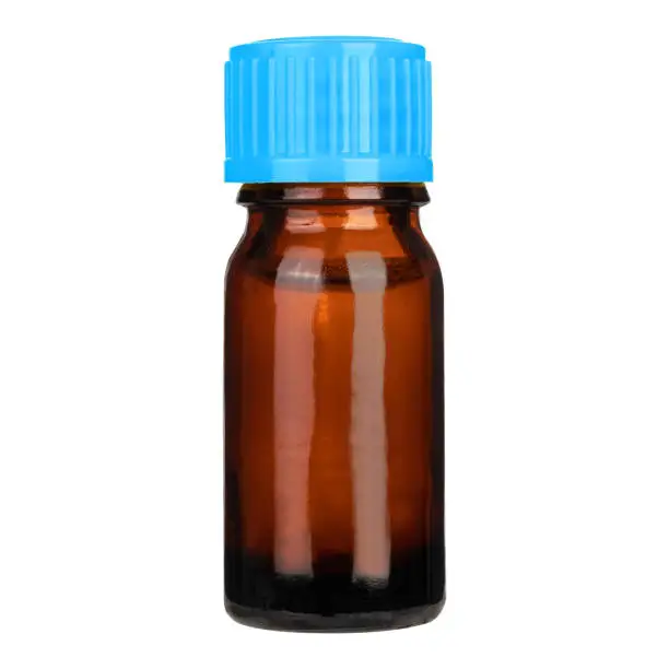 Photo of Essential oil bottles isolated on a white background. Blue cap