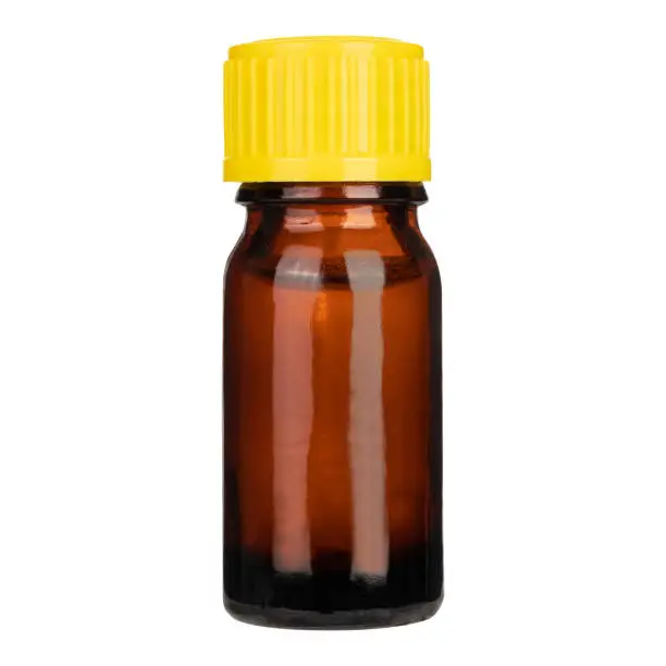 Photo of Bottle of amber glass with yellow cap isolated on white background. Mock-up.