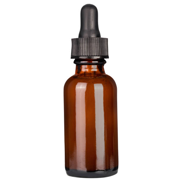 Amber vape liquid bottle isolated on white background. Dropper Bottle Mock-Up. Cosmetic bottle and pipette with essential oil on white background. Amber color pharma grade empty glass bottle with black cap and dropper. amber black photography stock pictures, royalty-free photos & images