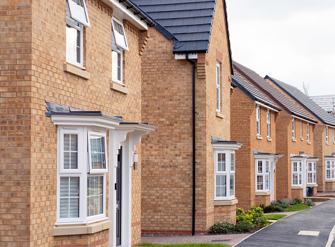 A street of recently finished newbuild brick houses in Milton Keynes, England.