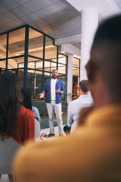 Shot of a young businessman talking during a conference at work