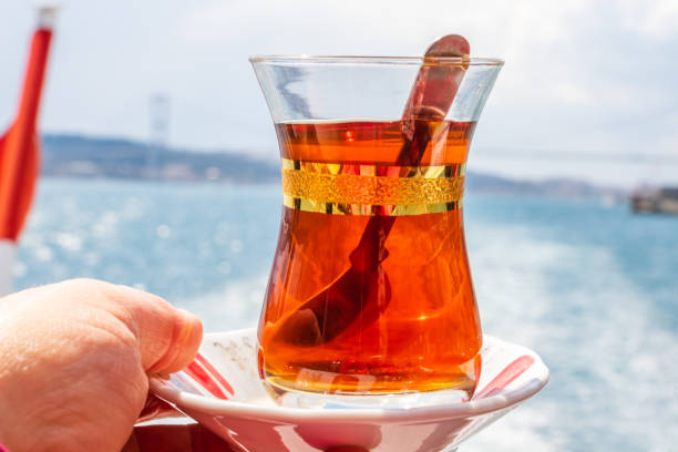 istock hand with turkish tea cup and flag. Travel concept 1347695748
