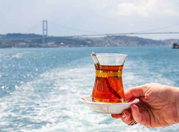 istock hand with turkish tea cup. Travel concept 1347695759