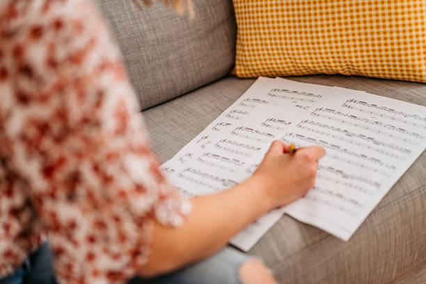 istock Young woman composing music at home 1347697988