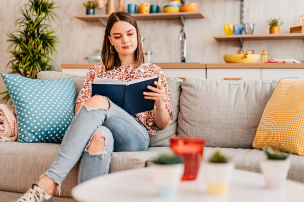 istock Woman At Home Lying On Reading Book And Drinking Coffee 1347700442