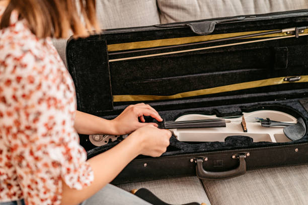 istock Woman  placing her violin in a case 1347700569