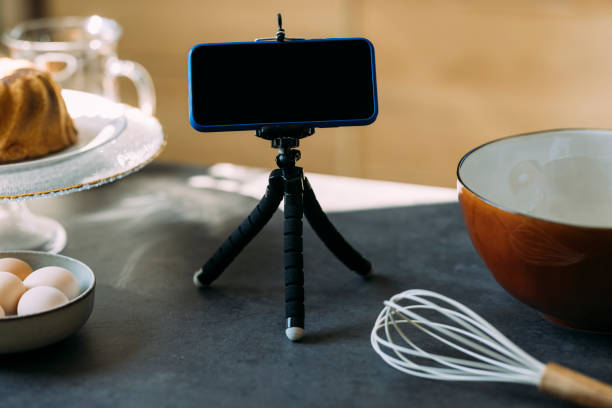 istock Pastry Chef's Vlog: A Smartphone on a Tripod Stand on the Kitchen Countertop 1347703356
