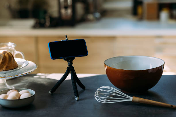 istock Pastry Chef's Vlog: A Smartphone on a Tripod Stand on the Kitchen Countertop 1347703361
