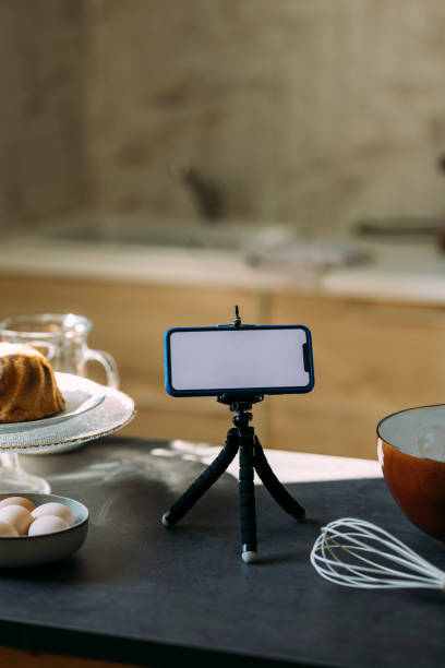 istock Pastry Chef's Vlog: A Smartphone on a Tripod Stand on the Kitchen Countertop 1347703364