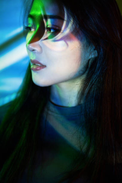 istock Beautiful woman in grey dress under neon light 1347703449