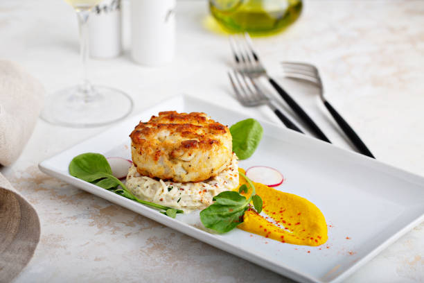 Gourmet plated fishcake with vegetables Gourmet plated fishcake or crabcake with vegetable puree, restaurant food fritter photos stock pictures, royalty-free photos & images