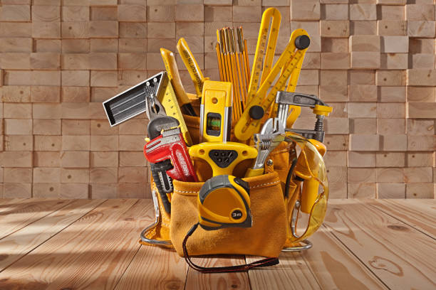 istock Big Set Of Carpenter Working Tools In Leather Toolbelt On Background of Wooden Beams Stack 1347703958