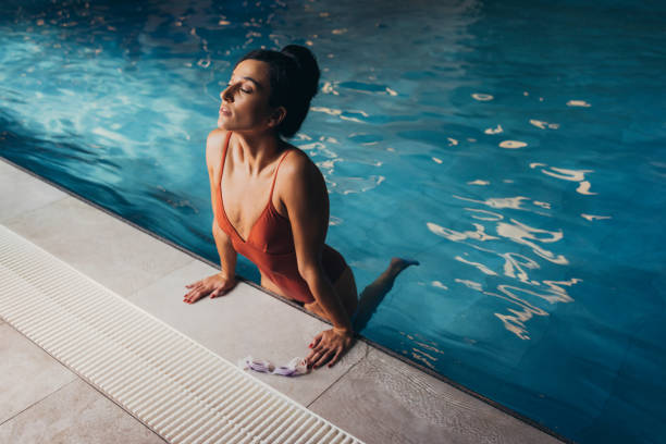 istock Beautiful Woman Enjoying in Hotel Pool 1347704040