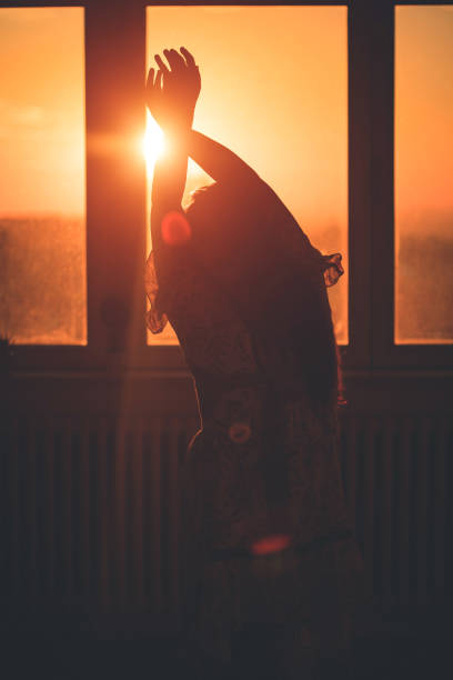 istock Woman in silhouette at window 1347704685