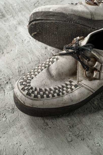 istock Used creeper shoes are white on the floor 1347705503