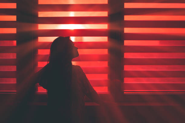 istock Woman in silhouette at window 1347706191
