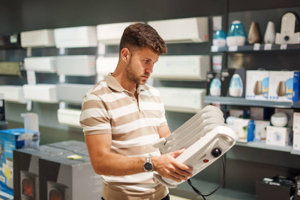 istock Man choosing radiator in shop 1347712352
