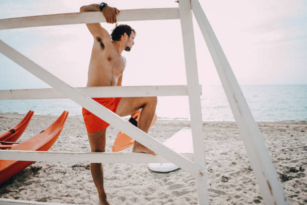 istock Rescue board and lifeguard watching at the distance 1347713163