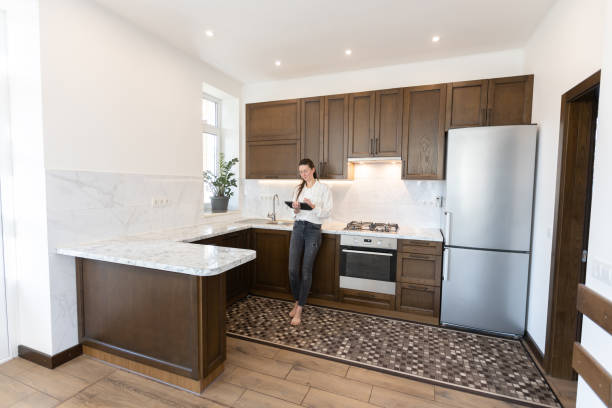 istock Woman working in her kitchen from home in a modern scandinavian kitchen 1347715115