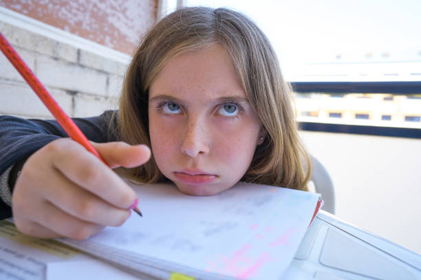 istock Bored student girl doing her homework 1347715489