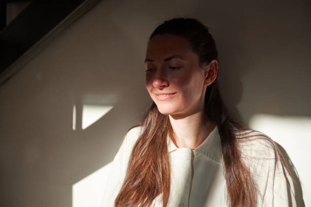 istock Woman portrait. She is smiling at home while relaxing in a shadow and sunlight 1347715509