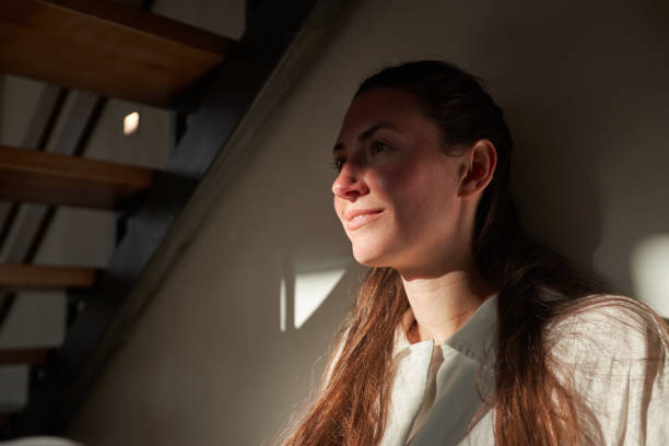 istock Woman portrait. She is smiling at home while relaxing in a shadow and sunlight 1347715534