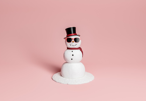 muñeco de nieve con gafas de sol, sombrero y bufanda photo