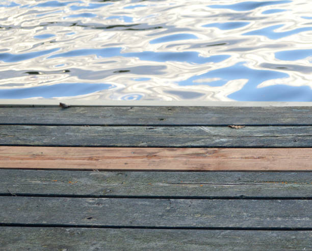 Wood jetty at lake being repaired