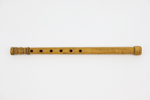 Traditional musical instrument - woodwind folk flute on the white background