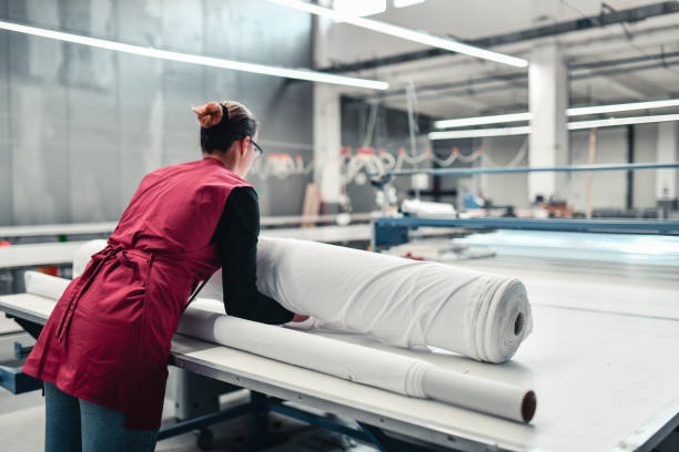 istock Female Textile Worker Putting Material On Printing Roller In Textile Factory 1347719737